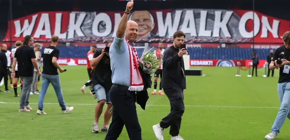 Person waving with flowers on football pitch