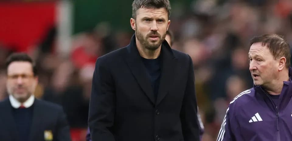 Coaches walking on the pitch during a match