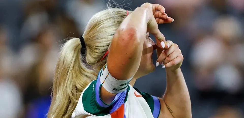 Athlete adjusting hair during a match