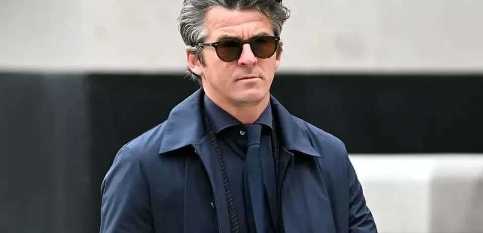 Man in sunglasses walking in urban setting