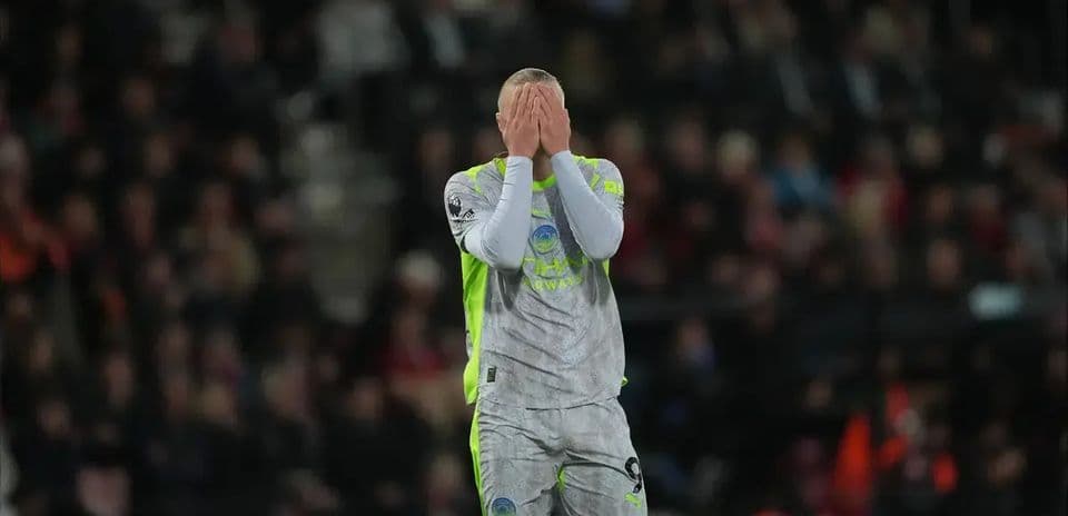 Goalkeeper covering face after conceding a goal