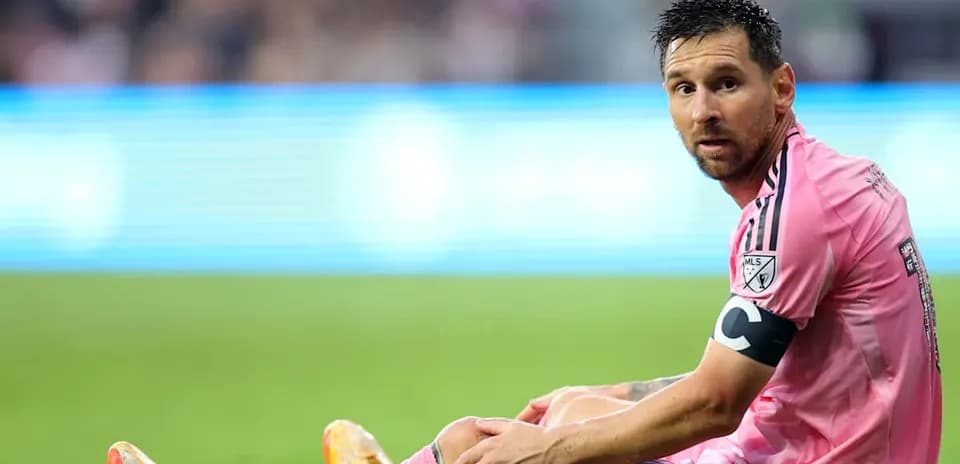 Lionel Messi sitting on the field during a match