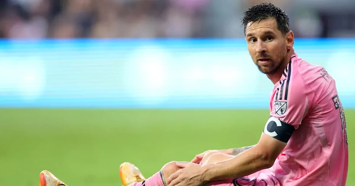 Lionel Messi sitting on the field during a match