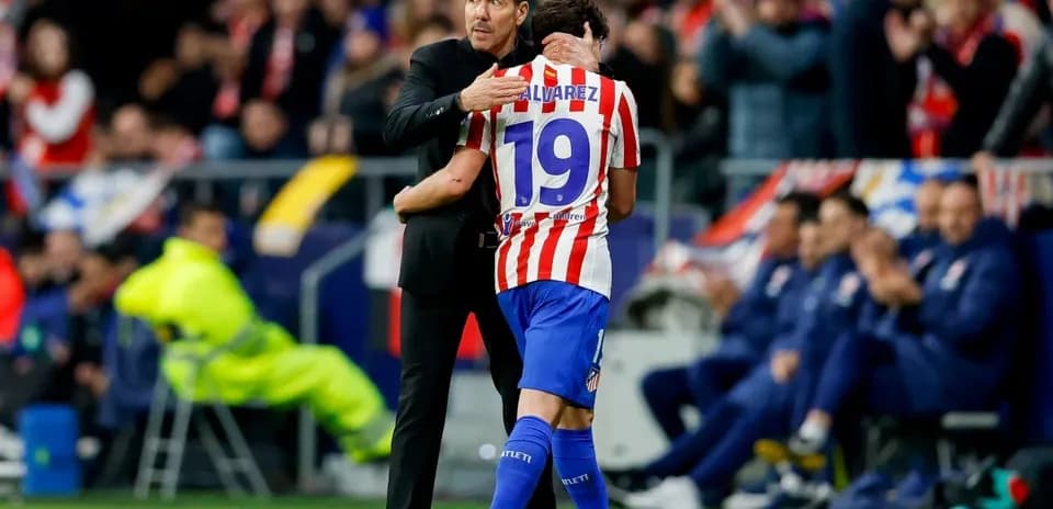 Coach hugging player during match celebration