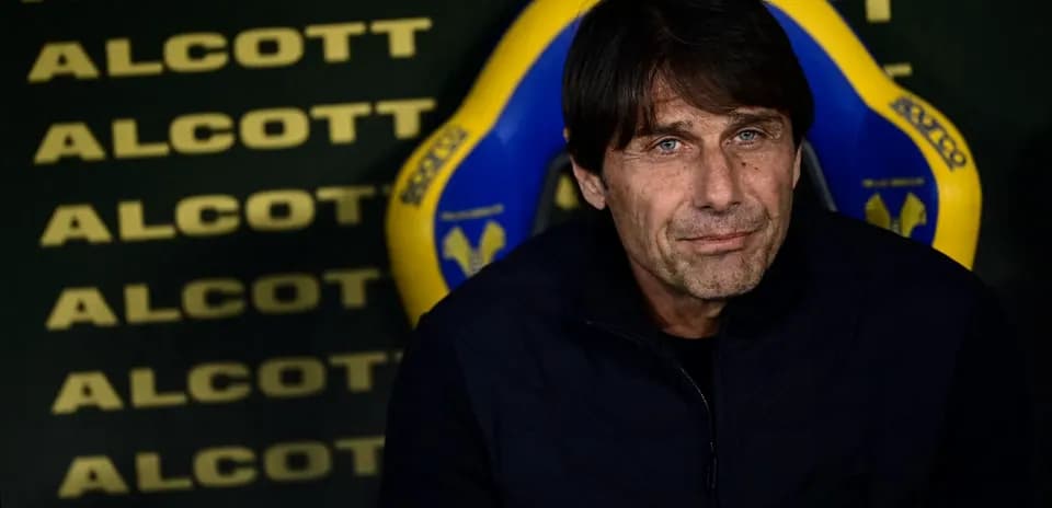 Coach seated on bench during match preparations