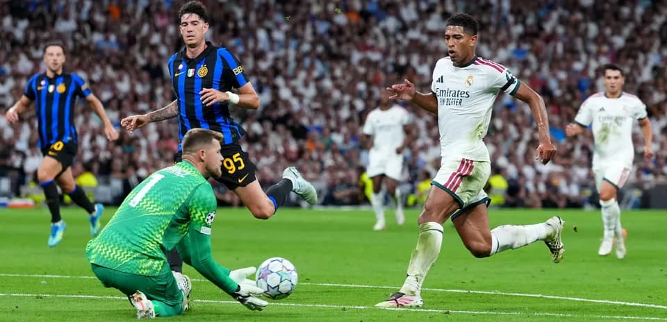 Real Madrid player running past goalkeeper during match