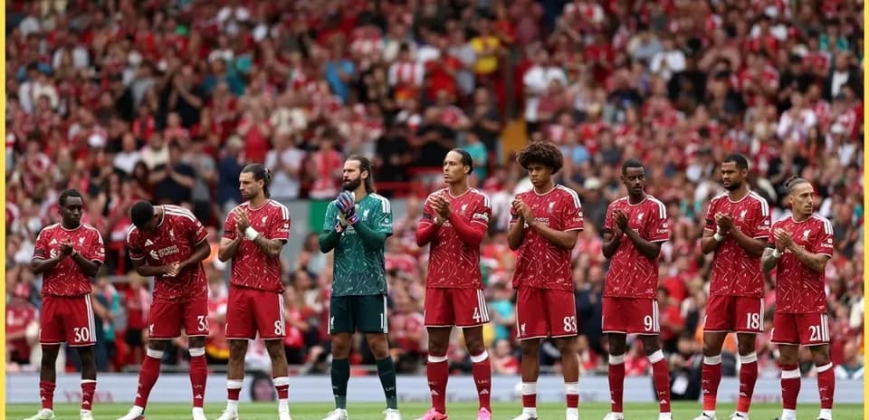 Liverpool players standing in line, clapping fans