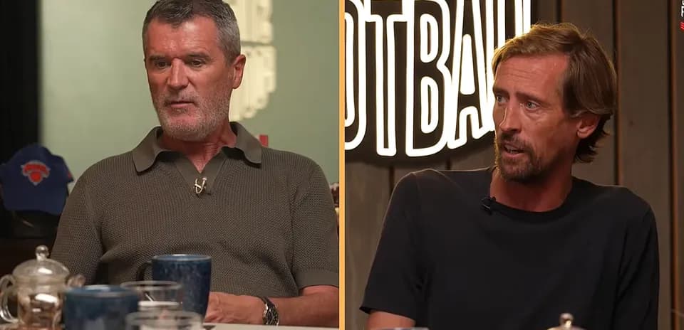 Two men discussing football at a table