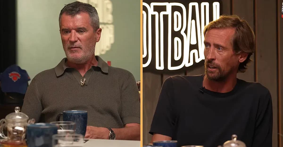 Two men discussing football at a table