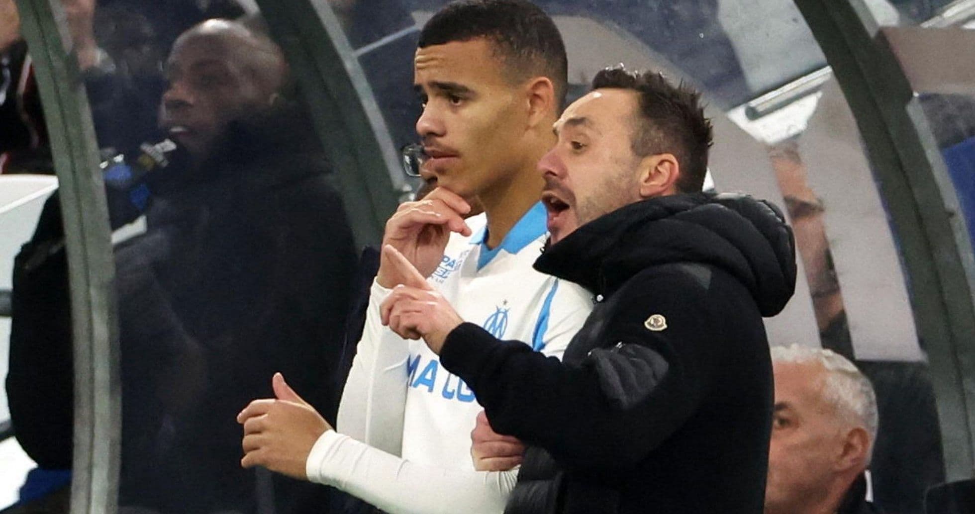 Coach instructing player on the sidelines during match
