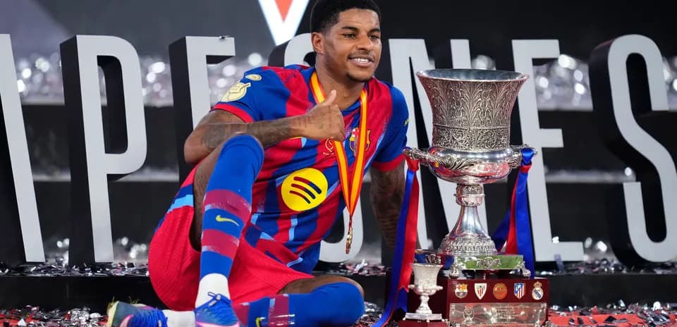 Barcelona player celebrating with trophy after victory