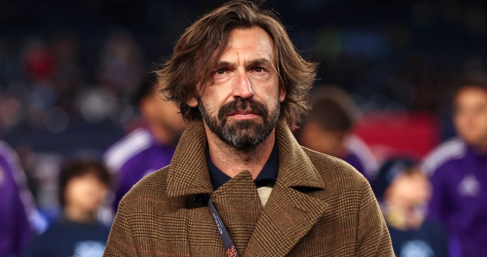 Coach on field during match preparations