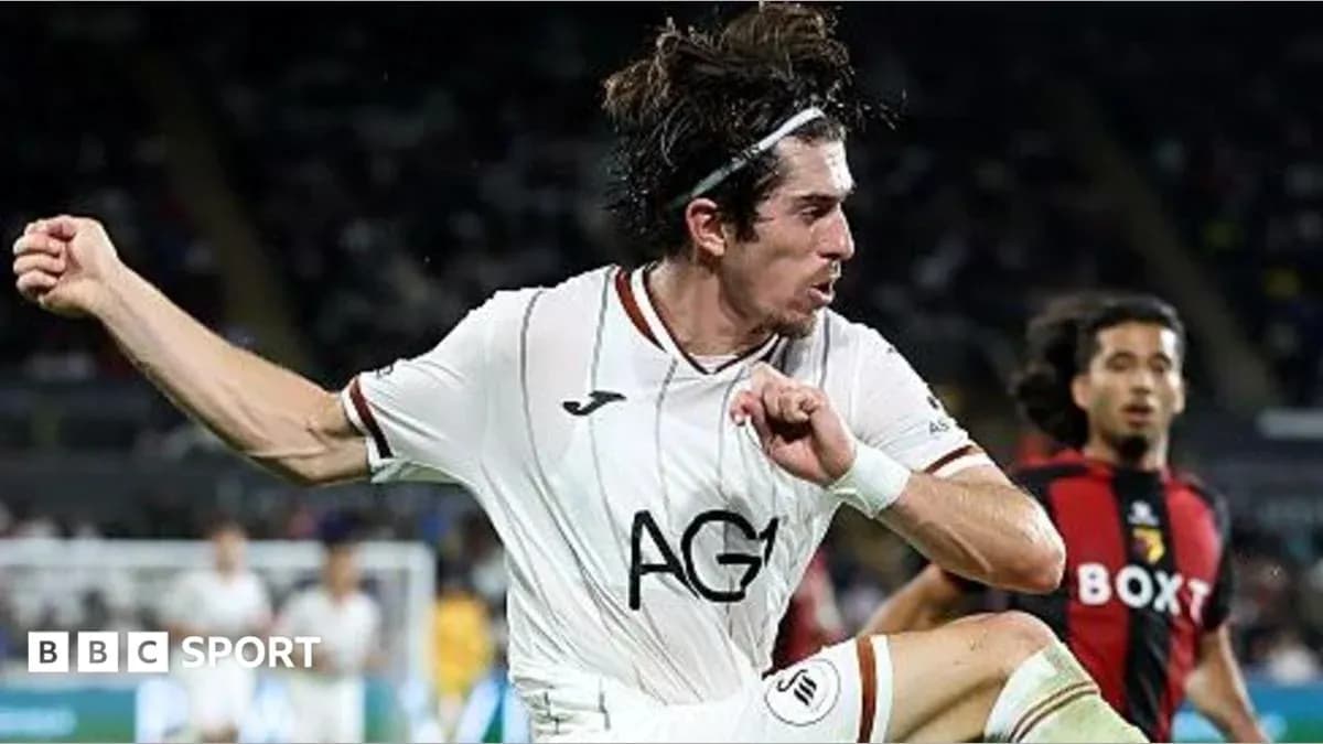 Player kicking ball during football match action