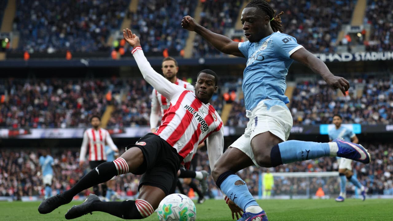 Player sliding to tackle during Manchester City match