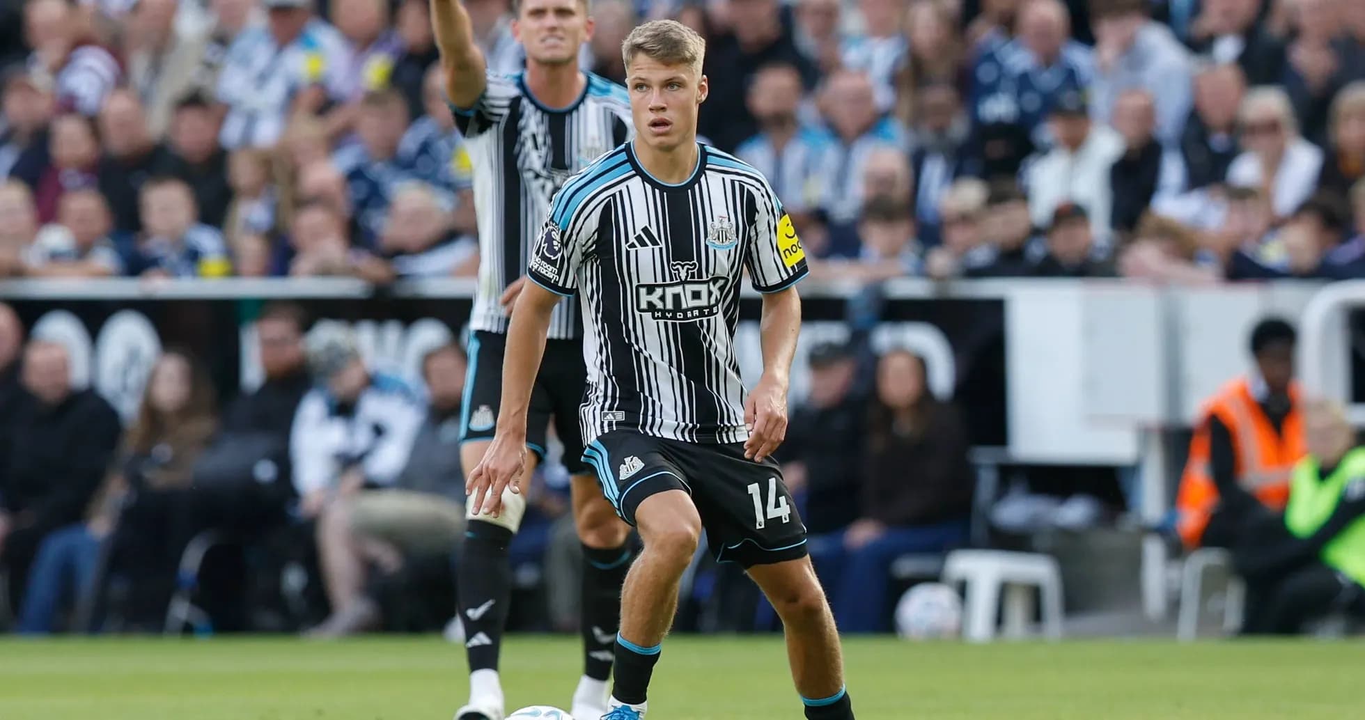 Newcastle player controlling ball during match action