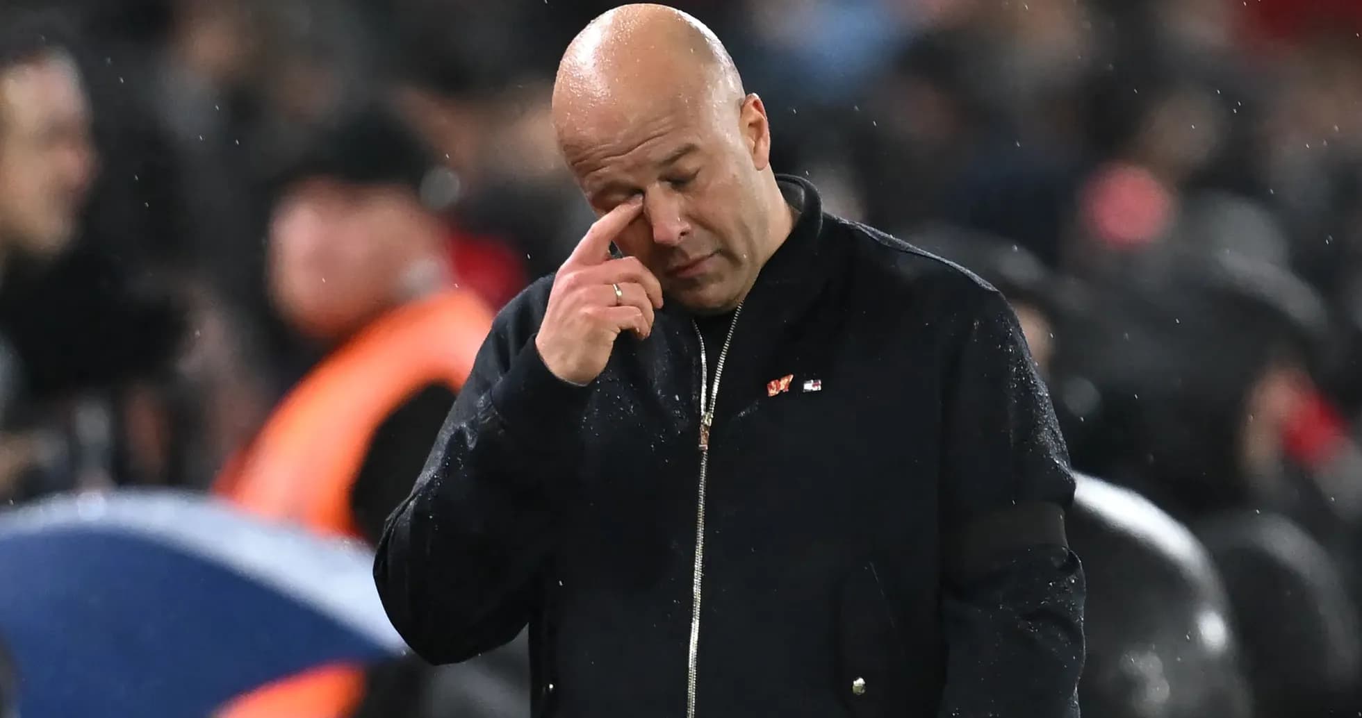 Coach wiping his face during a match