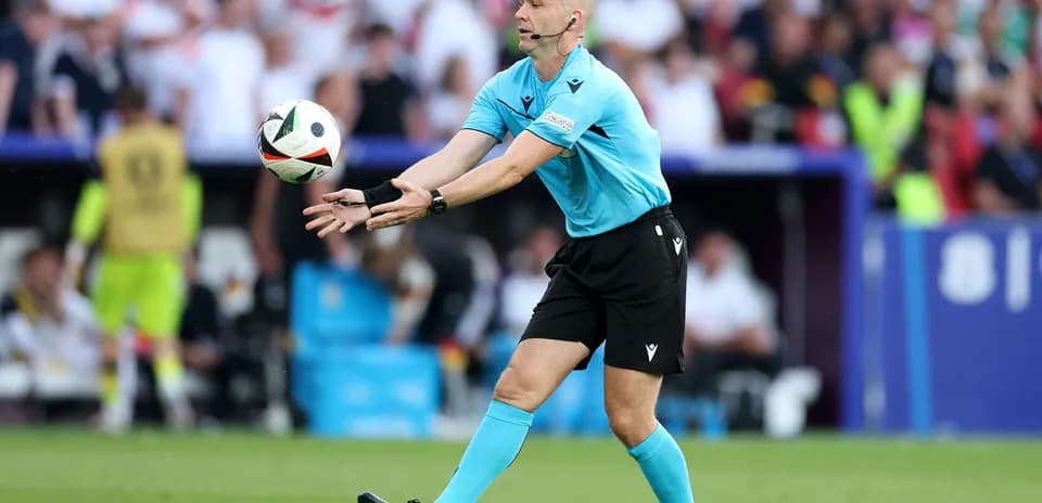 Referee signaling during a football match