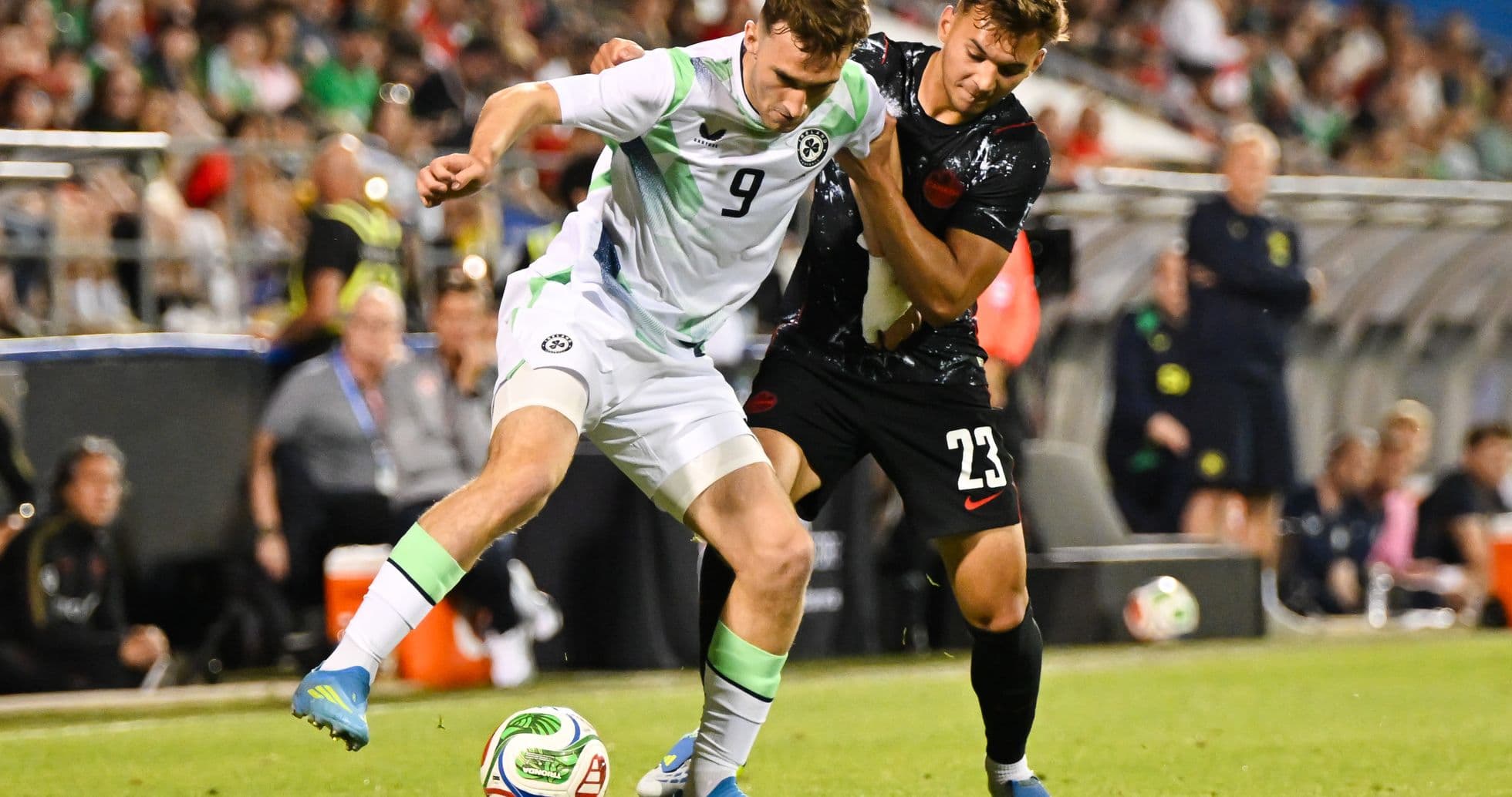 Two players battling for the ball during match