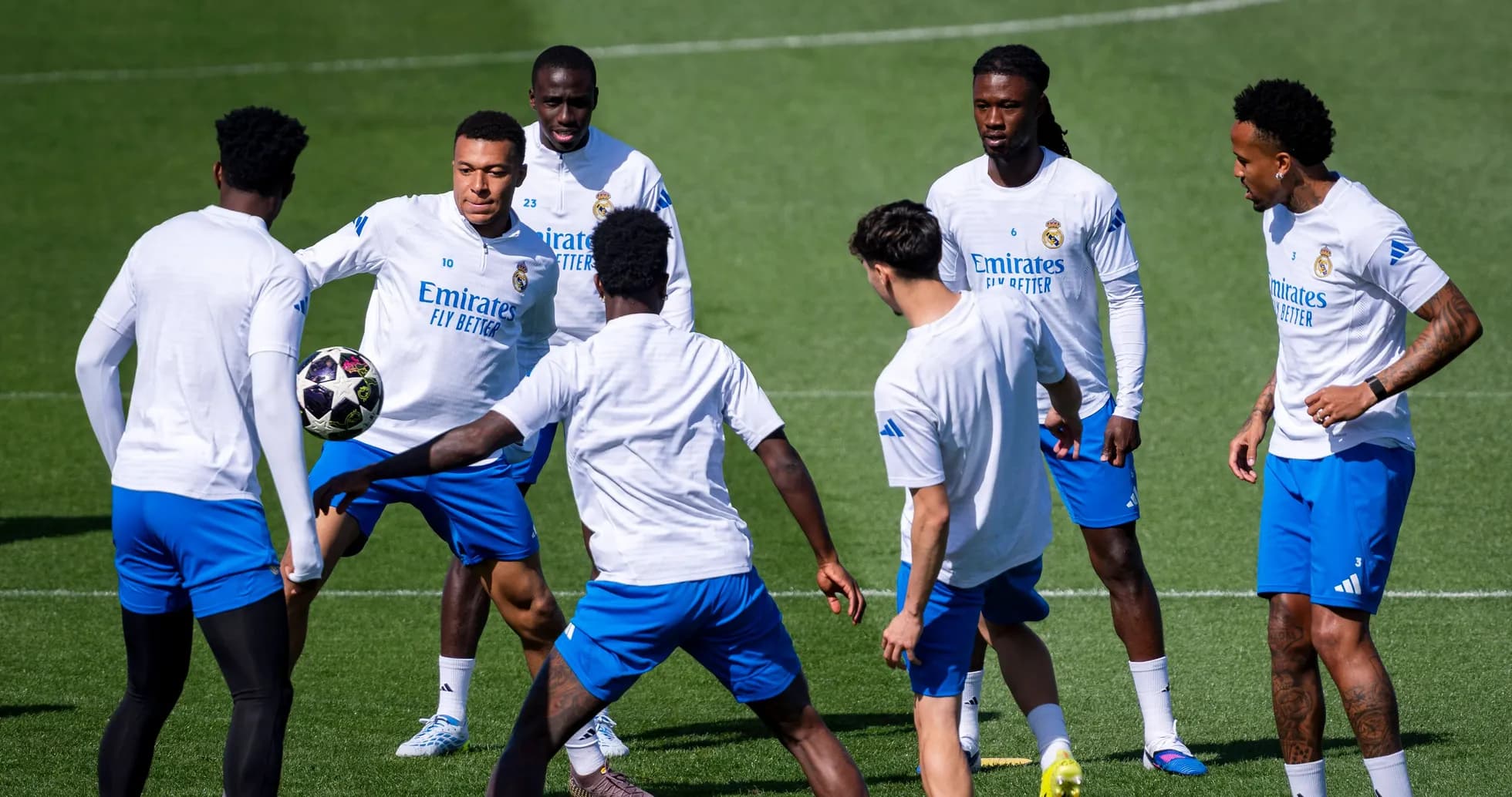 Real Madrid players training in a circle with ball