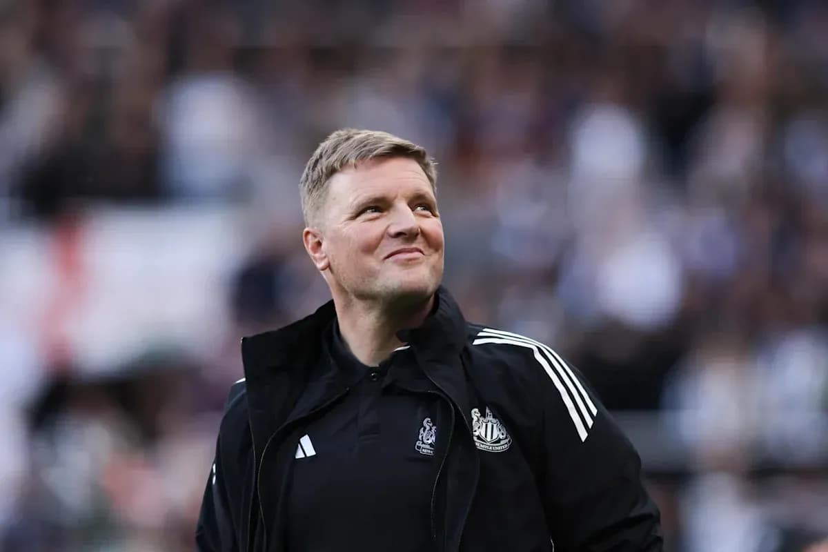 Newcastle United manager smiling on the sidelines