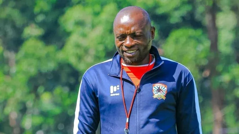 Coach in training gear smiling outdoors