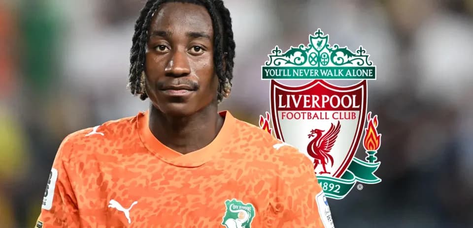 Goalkeeper in orange kit with Liverpool logo