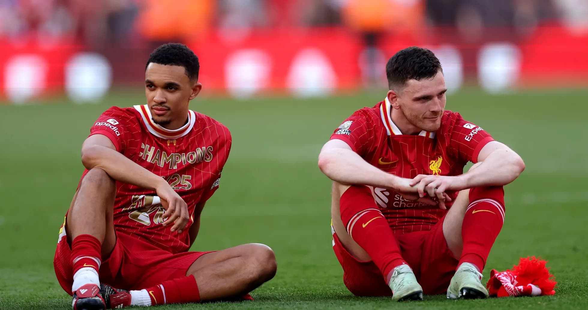 Liverpool players sitting on pitch after match