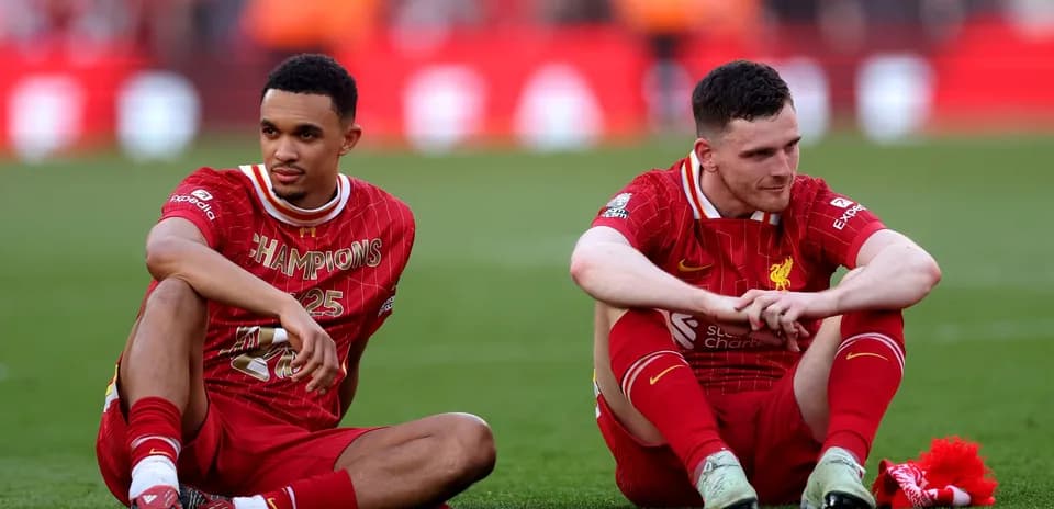 Liverpool players sitting on pitch after match