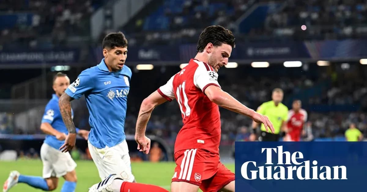 Arsenal player dribbling past opposing team during match