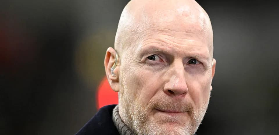 Bald man with earpiece at sports event