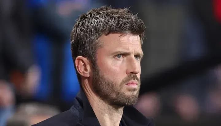 Men's football coach observing match from sidelines