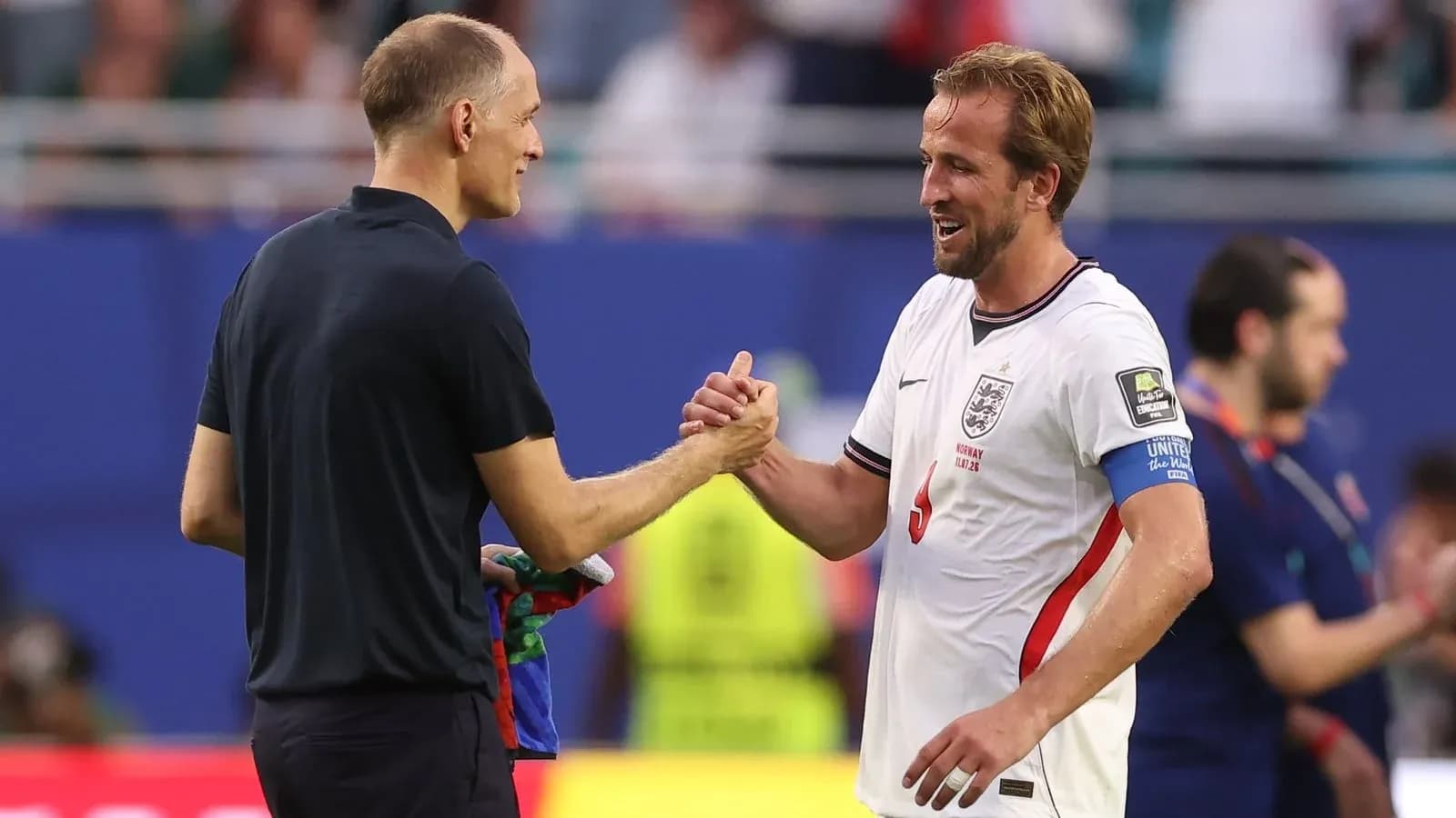 Men shaking hands after football match