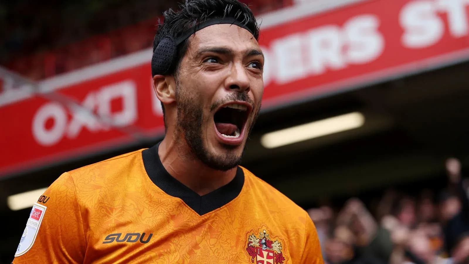 Player celebrating passionately in orange jersey