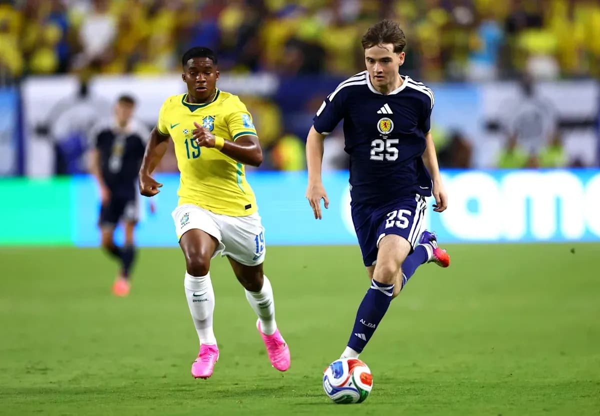 Player from Scotland dribbling past Brazilian opponent