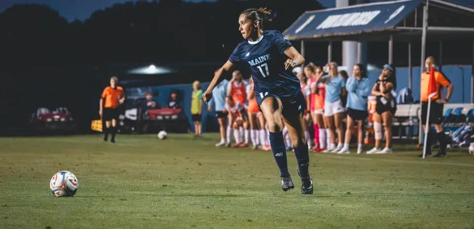 Maine player kicking ball during soccer match