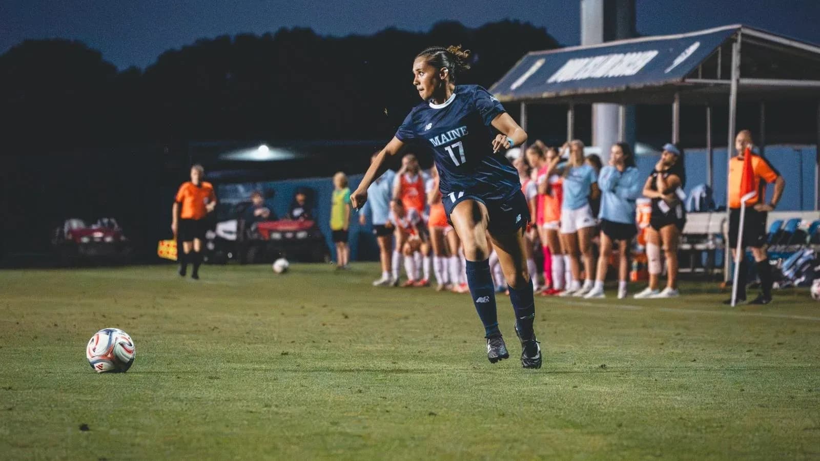 Maine player kicking ball during soccer match