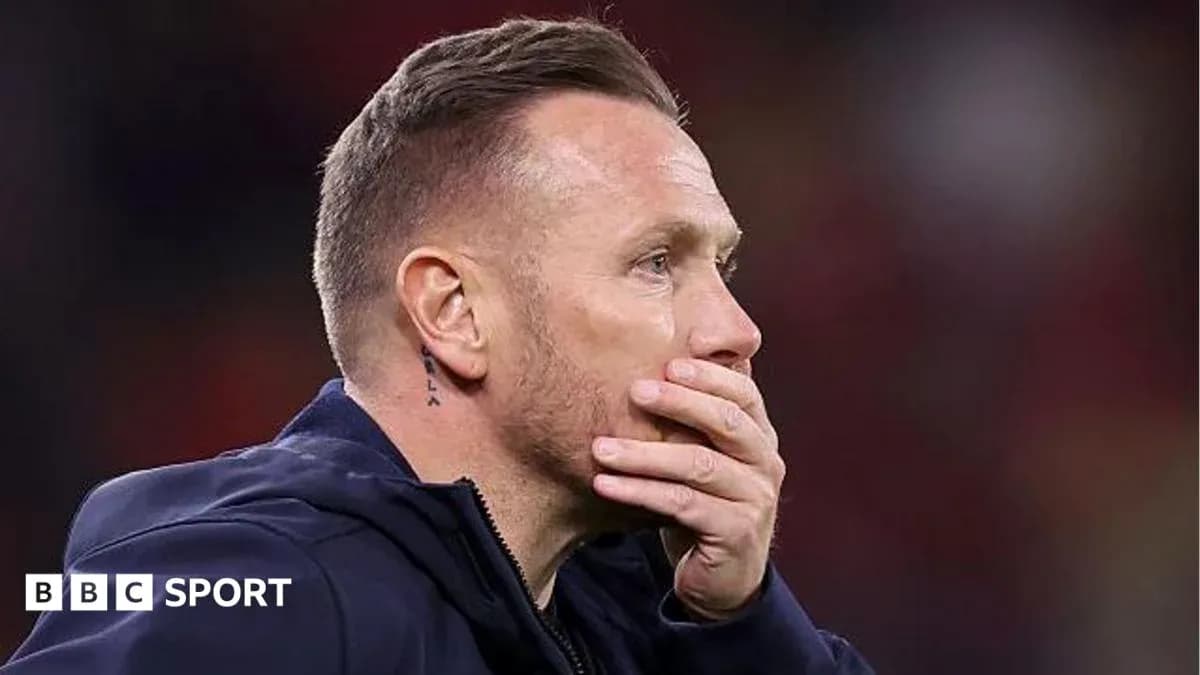 Coach with hand on face during match