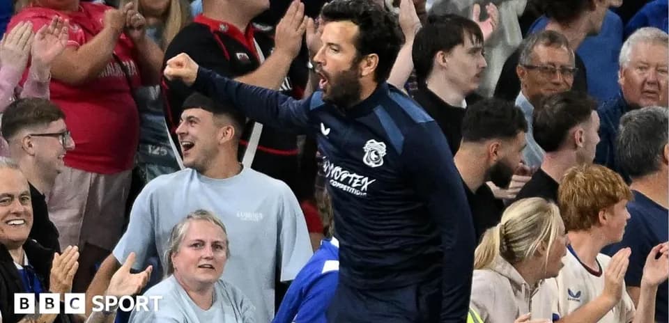 Football coach celebrating with fans in the stands