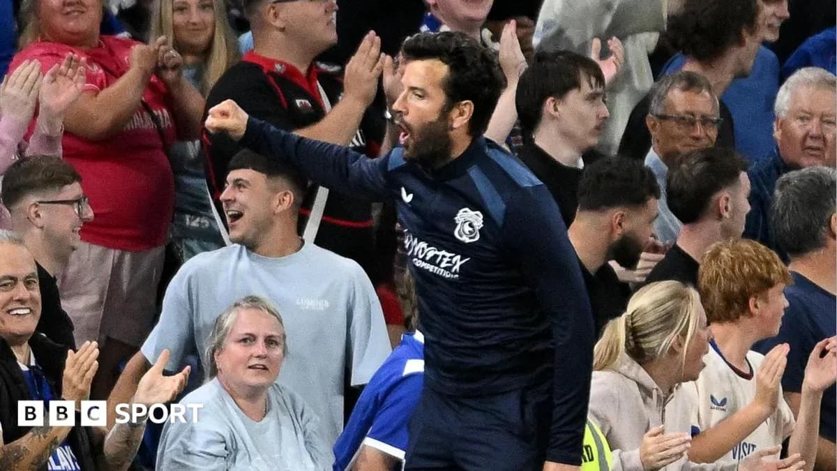 Football coach celebrating with fans in the stands