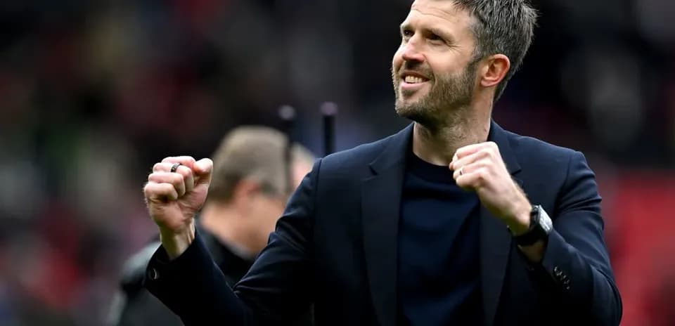 Coach celebrating with clenched fist on field