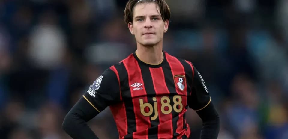 Bournemouth player in red and black jersey on field