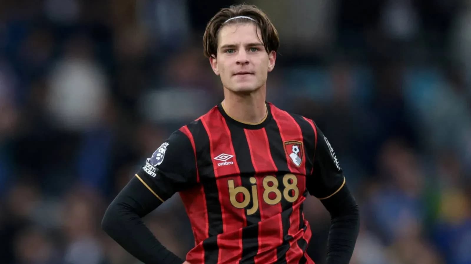 Bournemouth player in red and black jersey on field