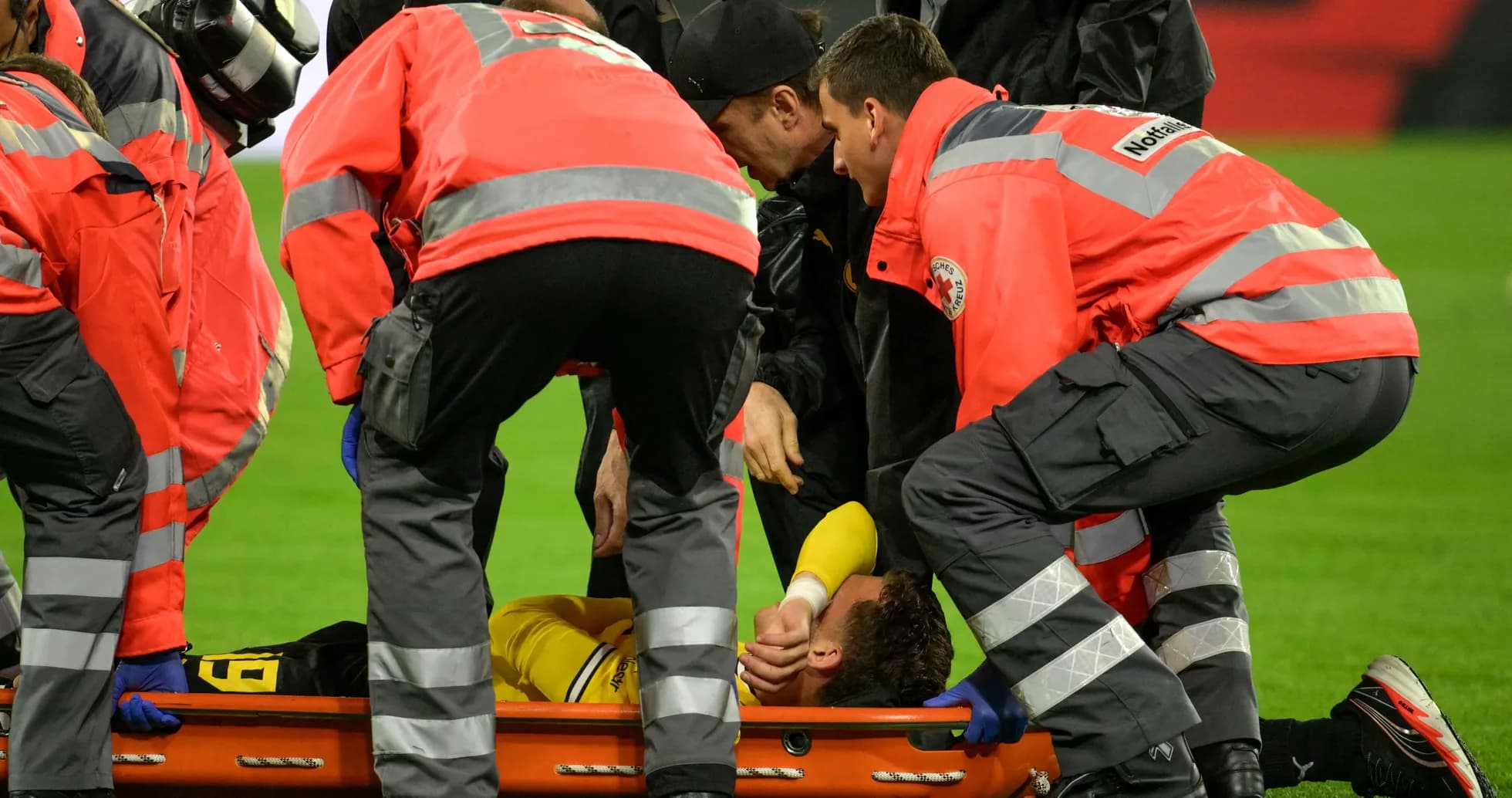 Medical team attending injured player on stretcher
