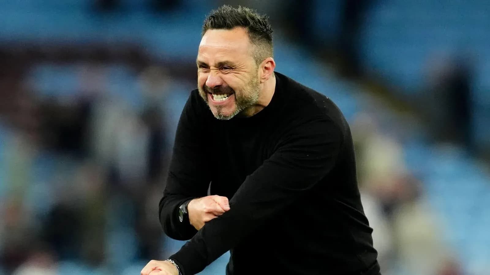 Coach celebrating passionately on the sidelines