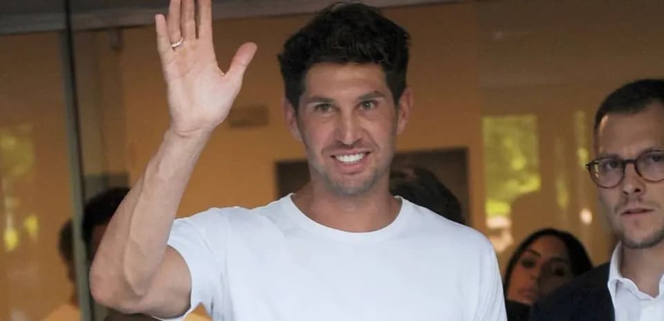Athlete waving while leaving a building