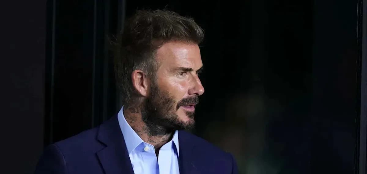 Man in suit with short hair and tattoos