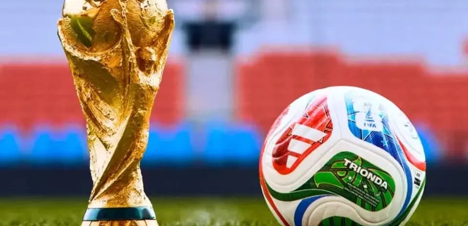 FIFA World Cup trophy and soccer ball on field