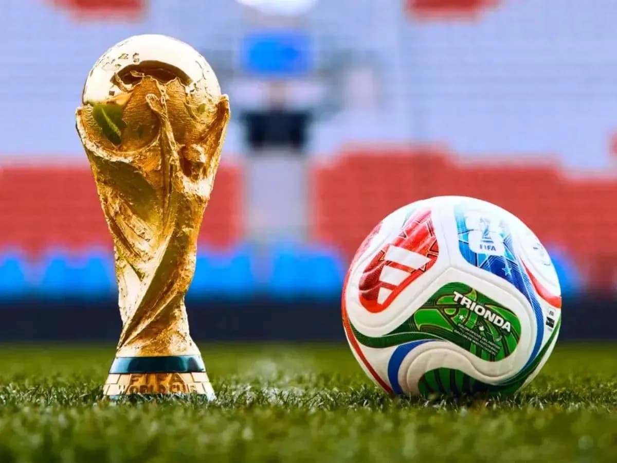 FIFA World Cup trophy and soccer ball on field