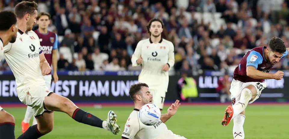 West Ham player shooting during match against opponent