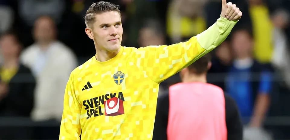 Goalkeeper in yellow kit giving a thumbs up
